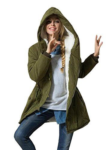 woman wearing a green jacket making a shhhh gesture with her hand